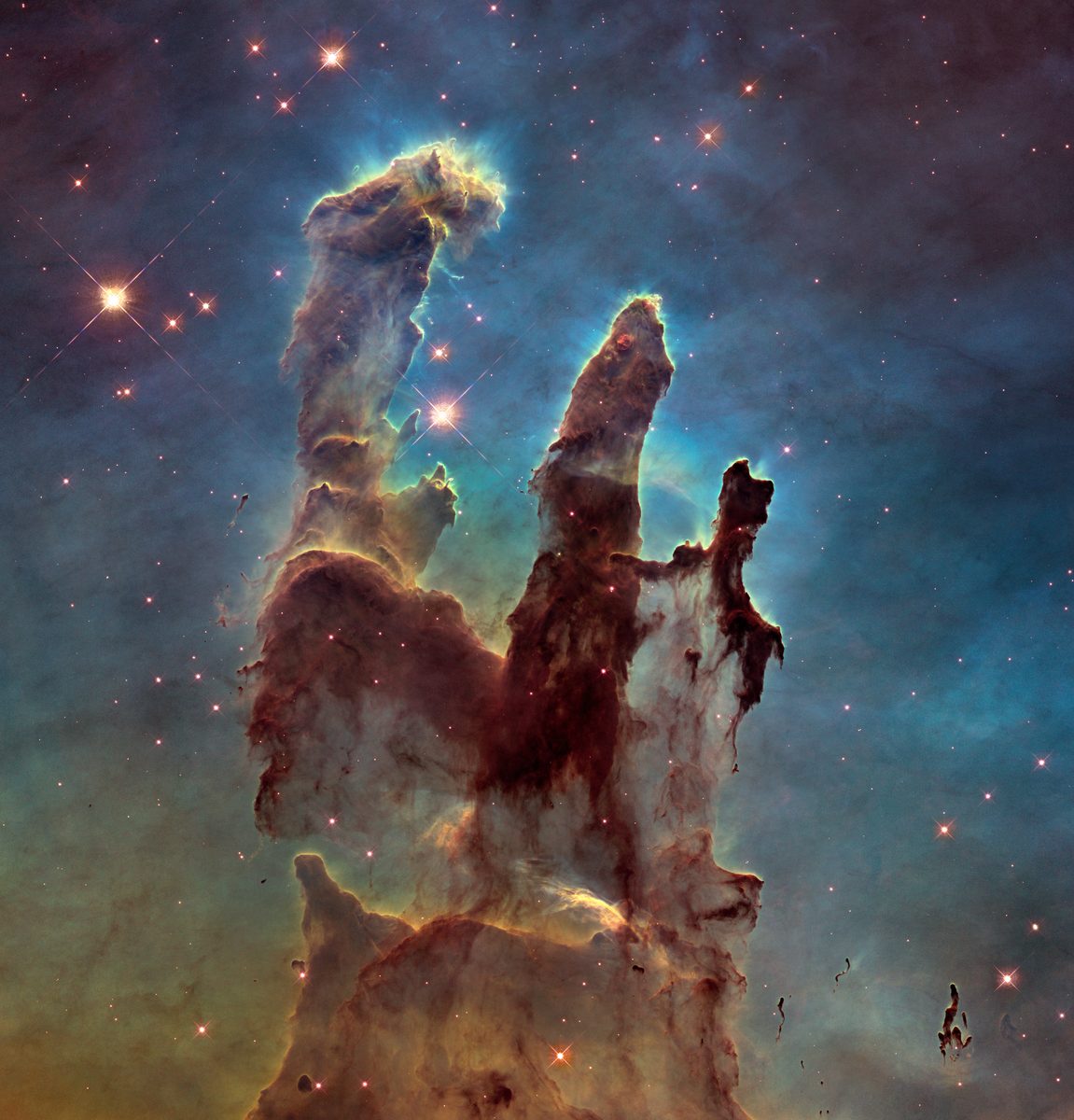 Hubble's 2014 visible-light image of the Pillars of Creation in the Eagle Nebula: three tall columns of gas and dust.